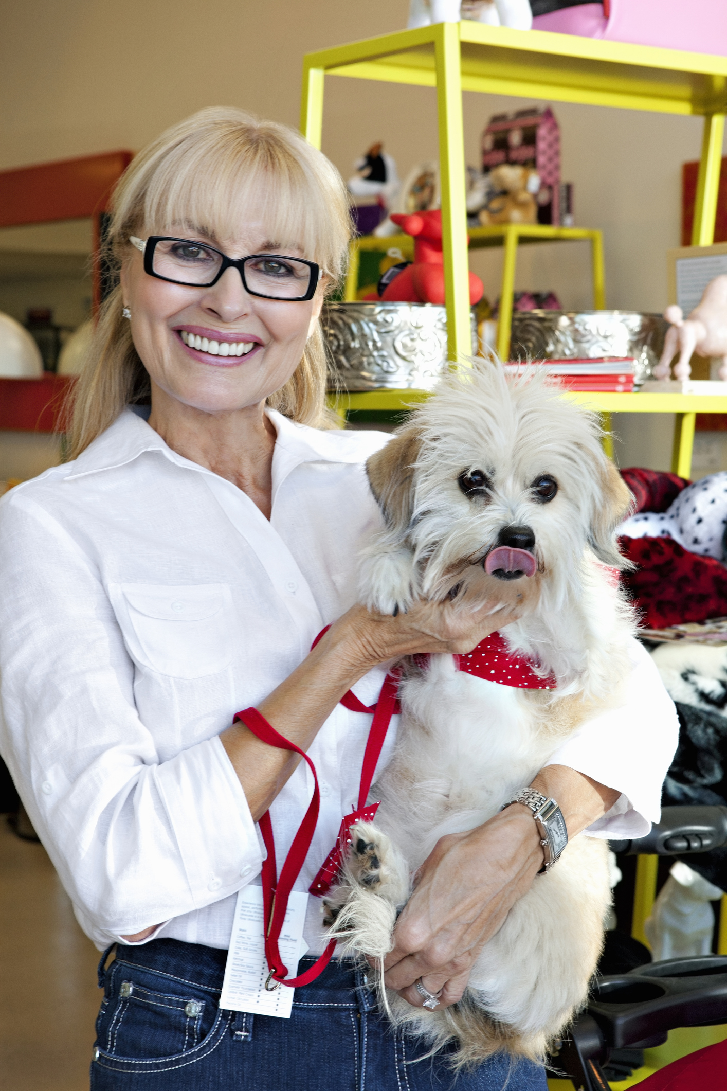 Portrait of pet shop owner carrying dog